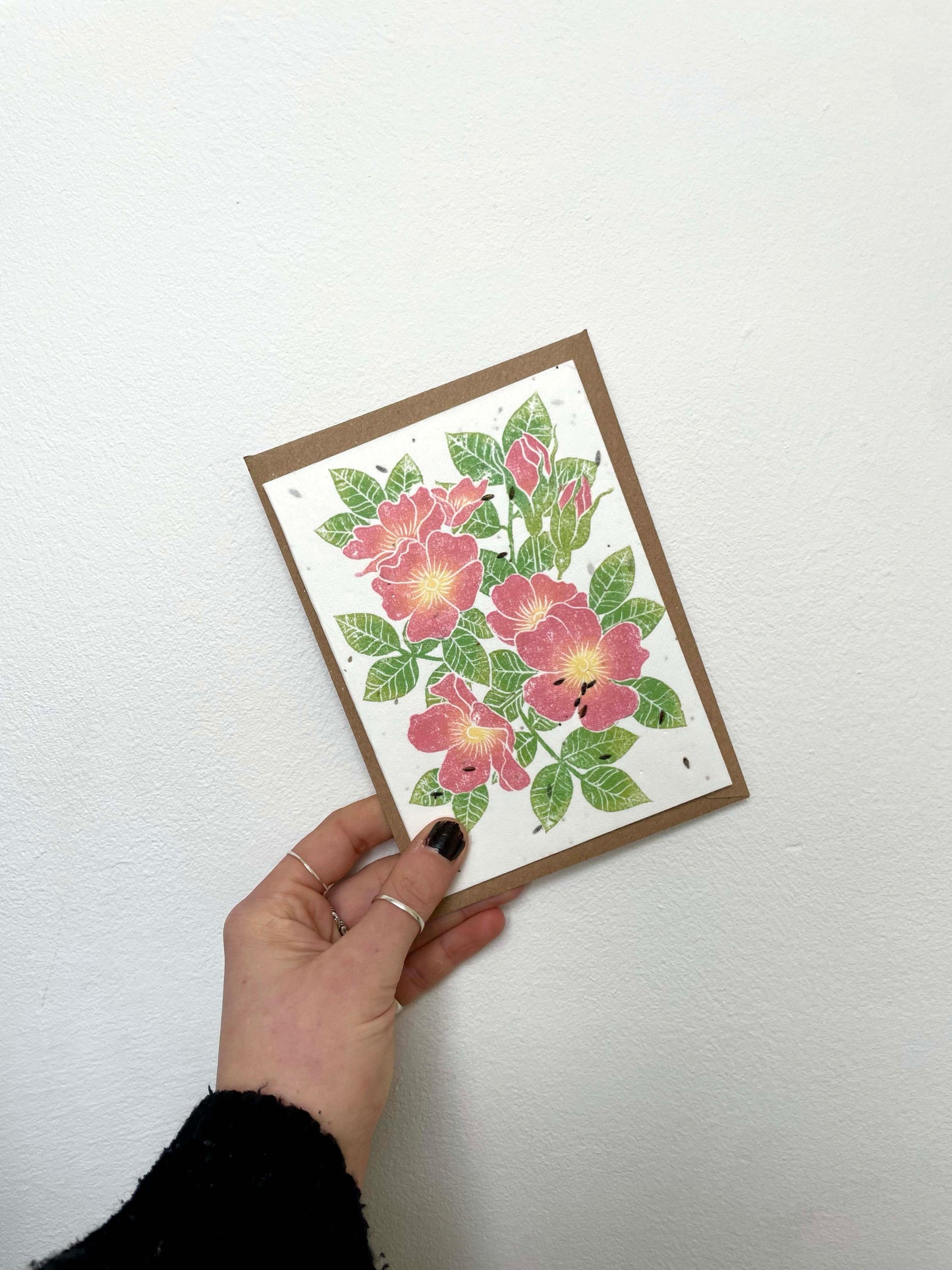 plantable seed card with lino printed pink dog rose design on recycled paper