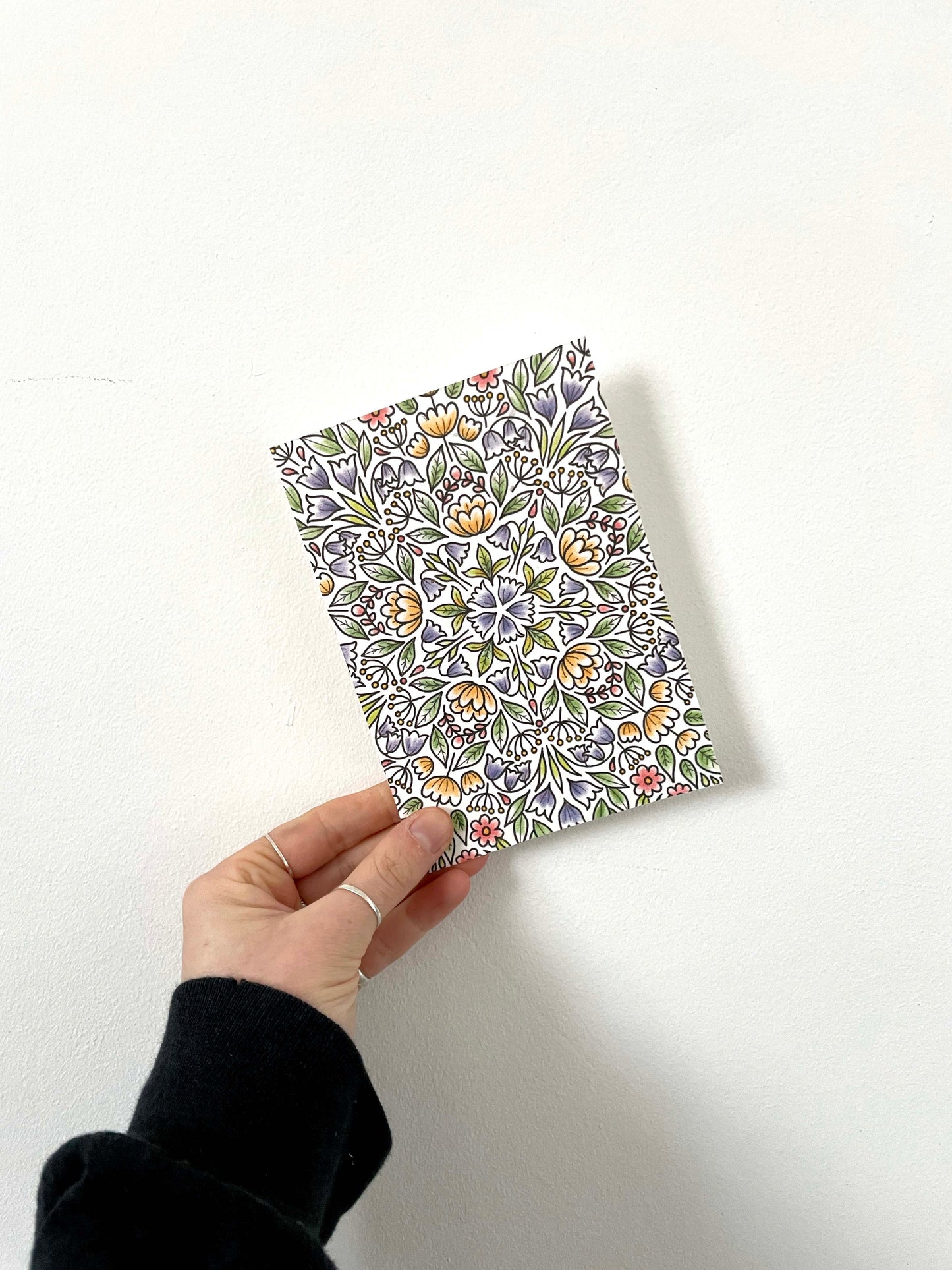 A seed paper greetings card with bold floral pattern with wildflower seeds embedded into recycled paper