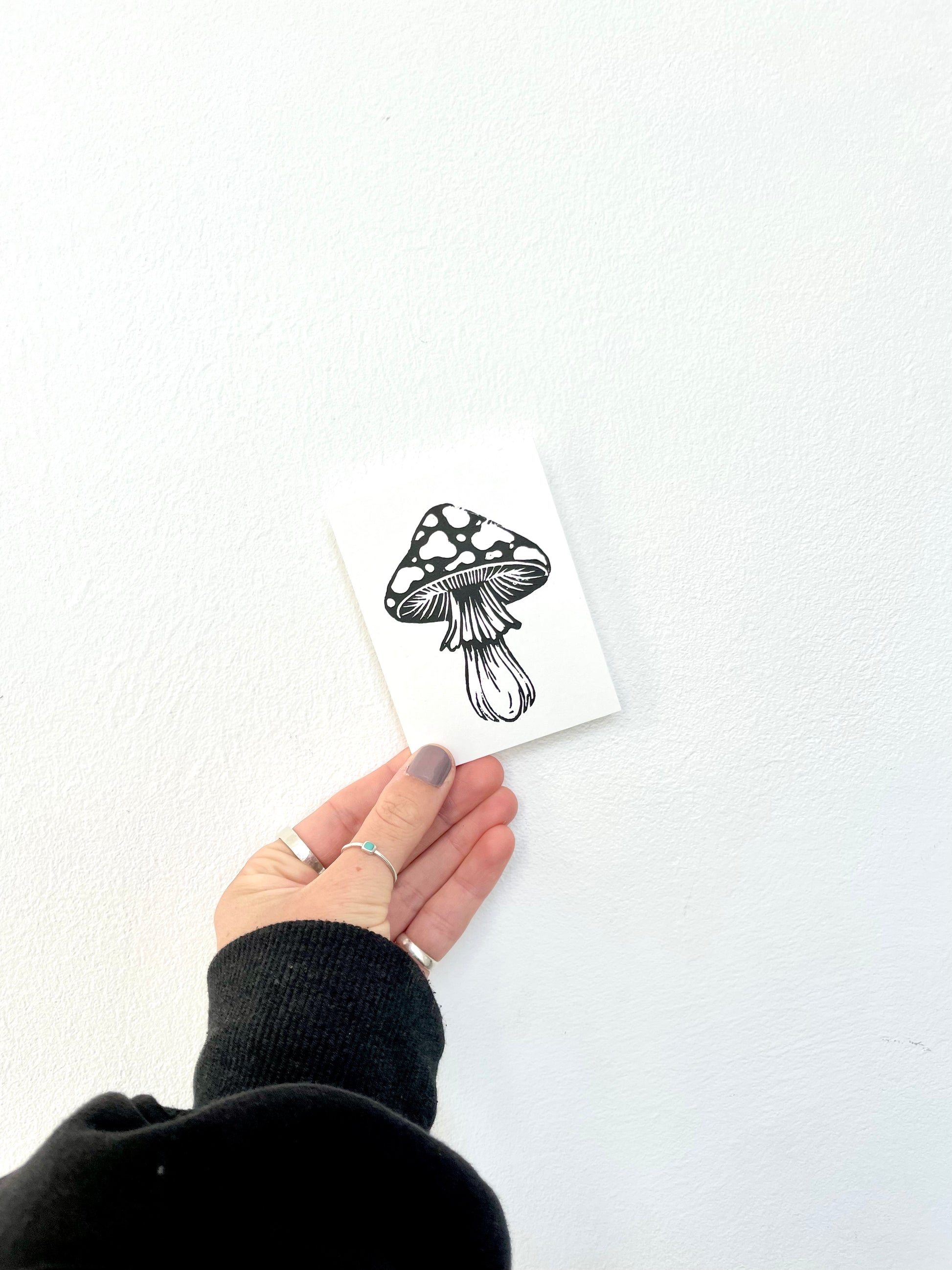 A lino print of a mushroom in black and white